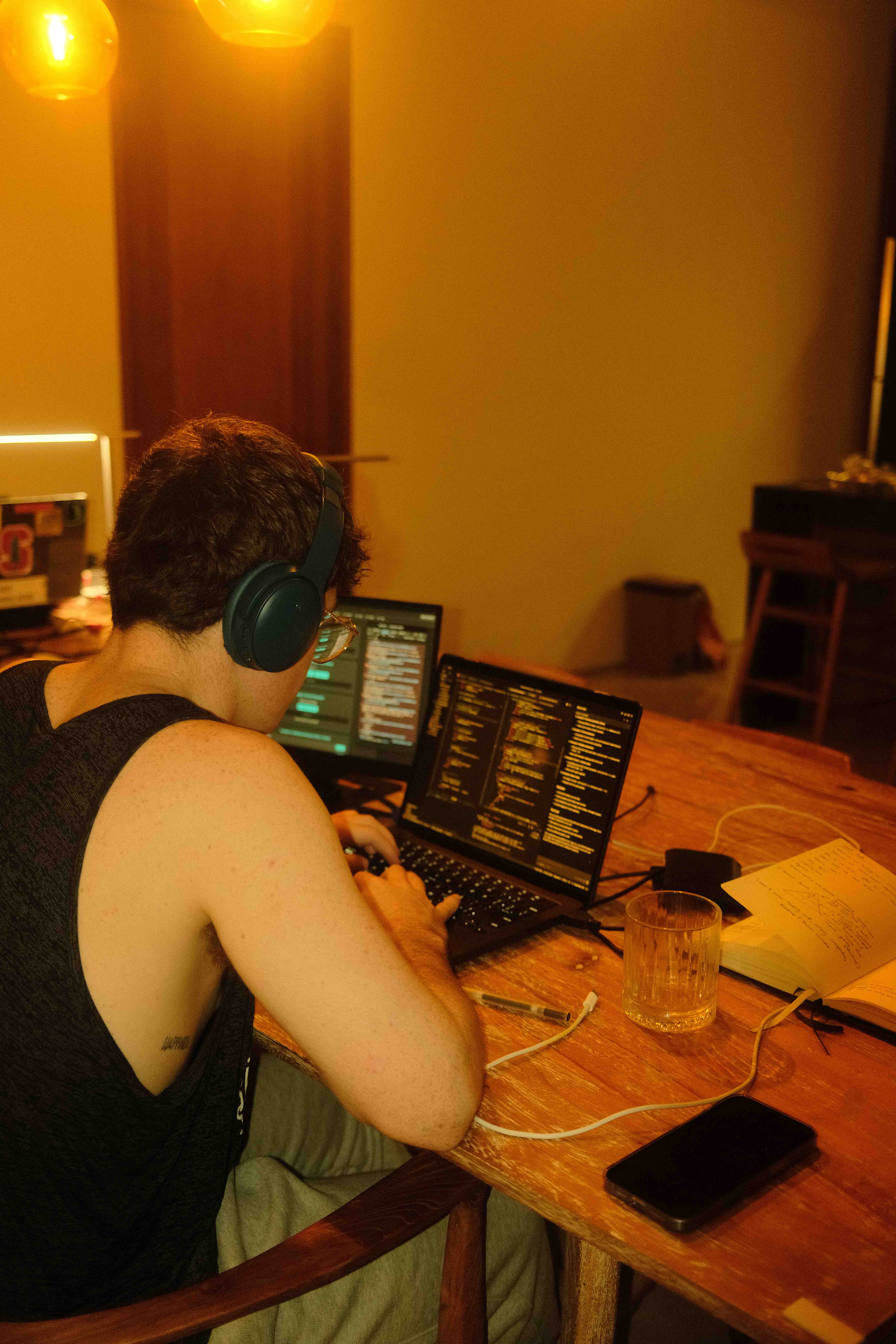 Team member working at laptop with headphones